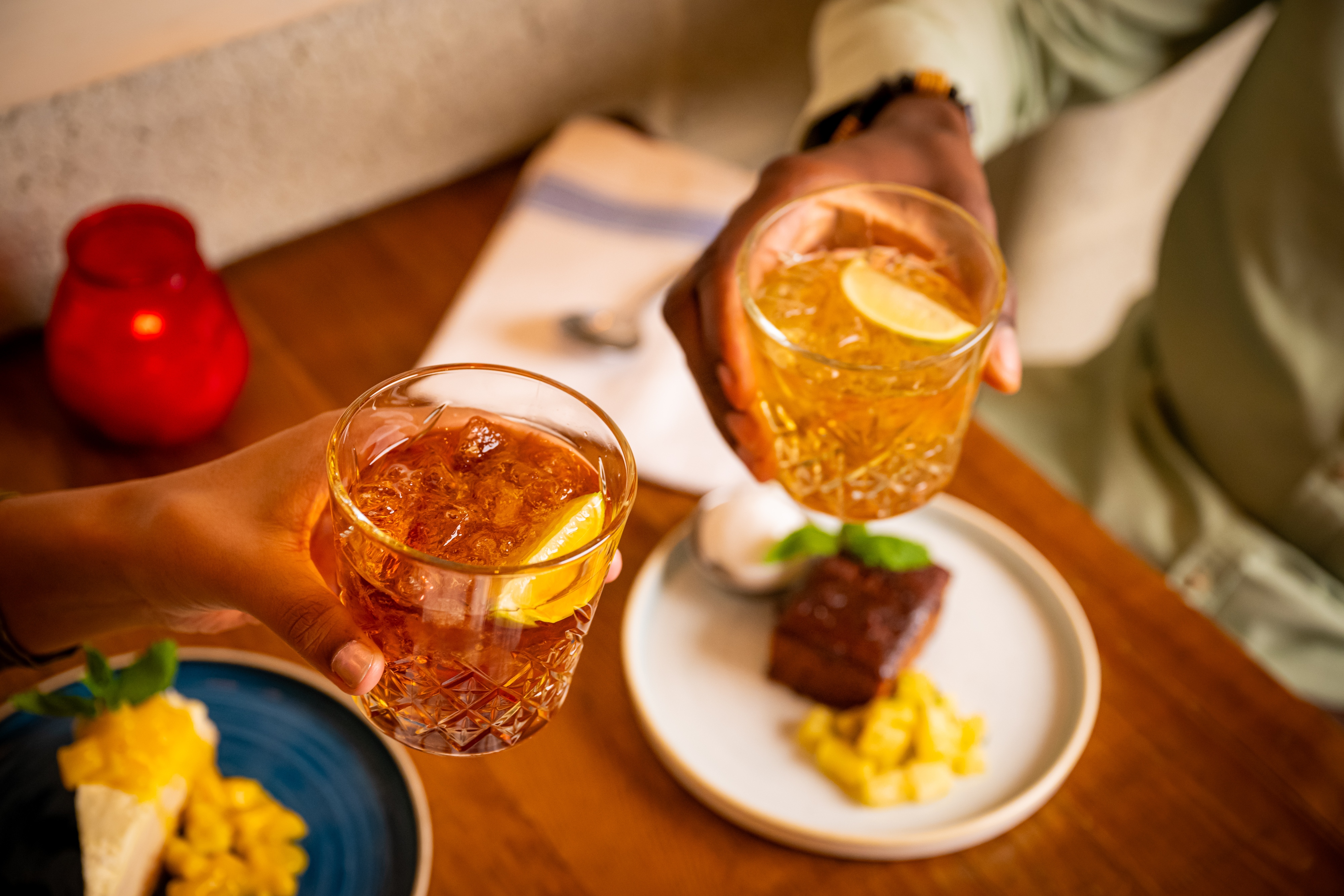 couple cheersing rum share with desserts