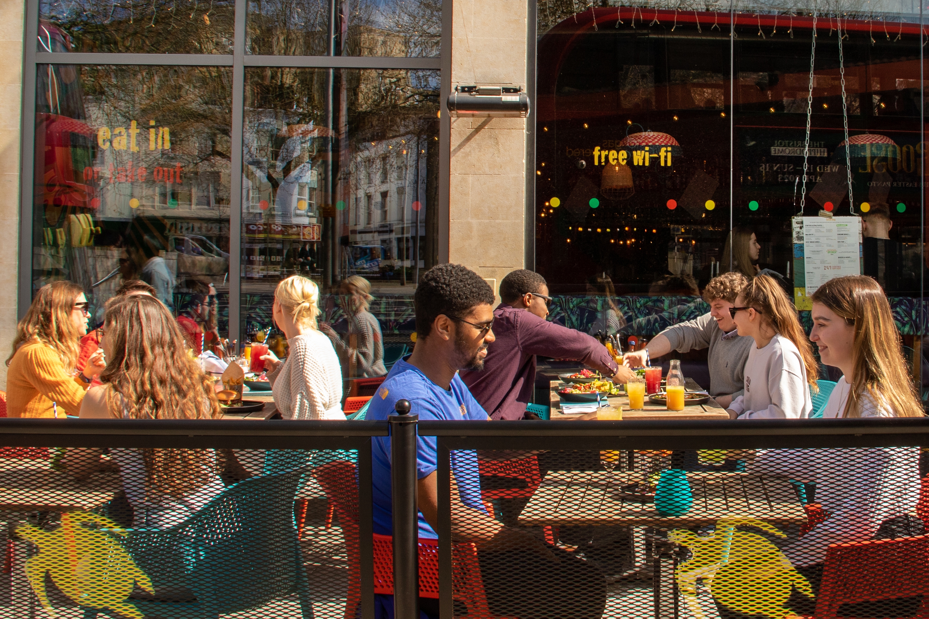 Guest enjoying food and drinks outside at Turtle Bay in the sunshine