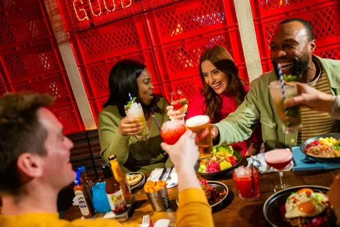 A Group of Friends Cheers with Food and Cocktails Neon Sign 9